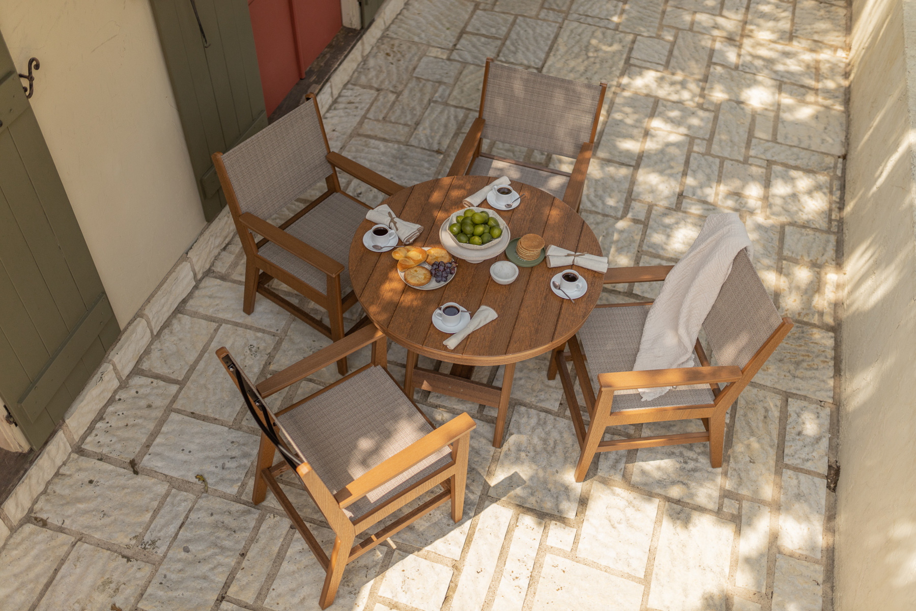 Mayhew Sling Dining Chairs shown with the Harbor Table